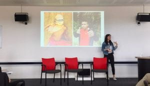 Image of two Matses children on the screen, and Camilla Morelli speaking