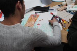 A young man draws a picture